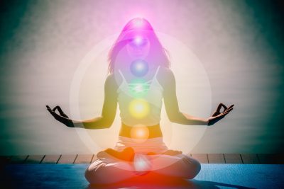 Young woman in yoga meditation with seven chakras and Yin Yang s